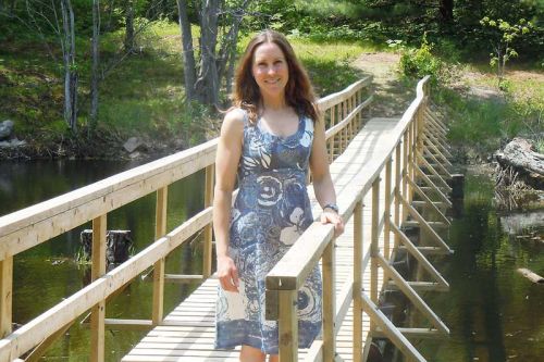 Carolyn Bonta, manager of the Elbow Lake Environmental Education Centre on the new footbridge that was unveiled at the centre's annual open house, May 23